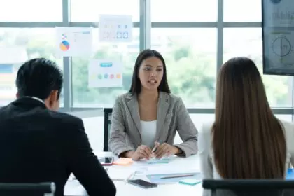 A group of young Asian entrepreneurs. Top Management is meeting to review stock investment data