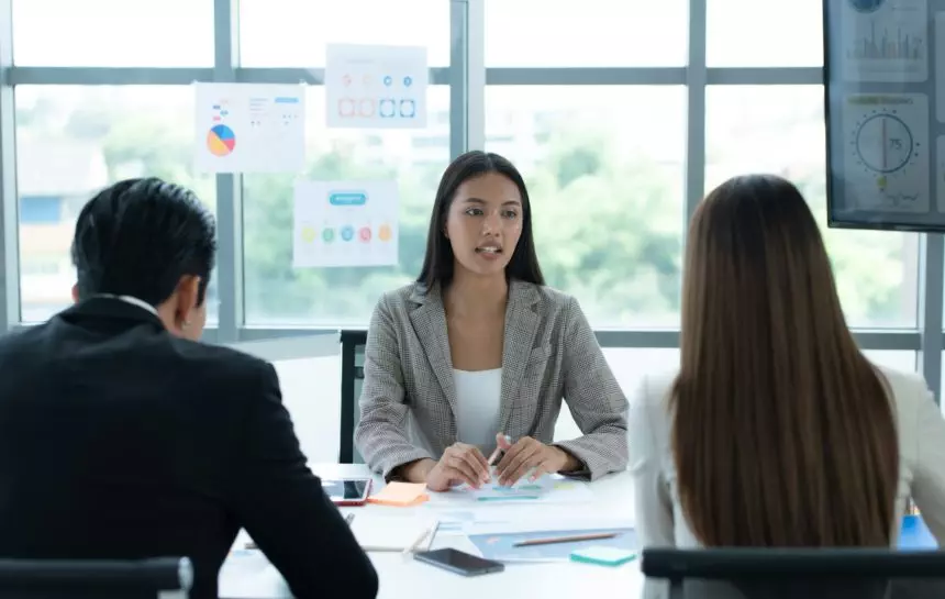 A group of young Asian entrepreneurs. Top Management is meeting to review stock investment data