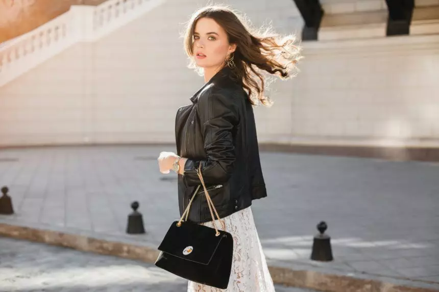 attractive woman walking in street in fashionable outfit