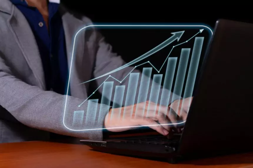 Entrepreneur analyzes economic and financial growth. Investment chart and economic trends.