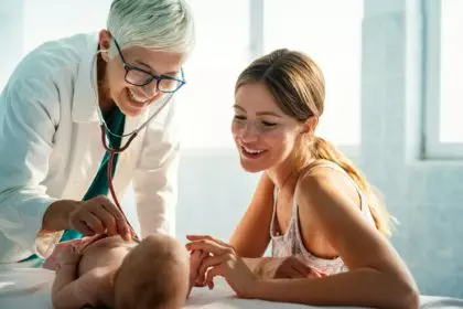 Pediatrician examining little baby to prevent diseases