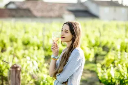 Woman tasting wine outdoors