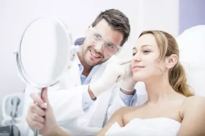 Aesthetic surgery, woman looking in mirror
