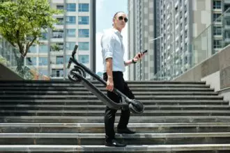 Businessman with electric scooter