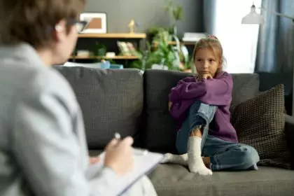 Difficult child talking to psychologist at home