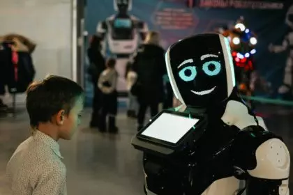 Futuristic robot talking to a boy at an exhibition of modern technologies. Education, future. N