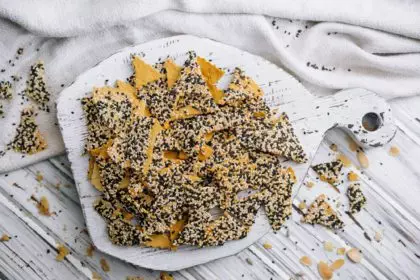 Salted tortilla chips triangle with chia seeds on top view