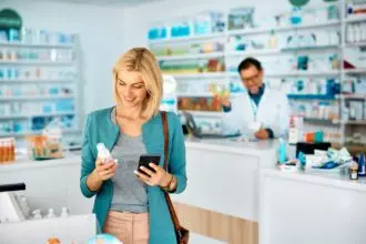 Happy woman buying skin care products in a pharmacy,