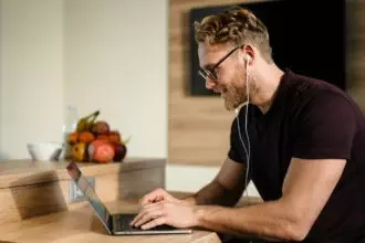Young man working remotely and heaving a meeting