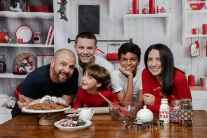 Happy family together in a kitchen during the Christmas holiday - the concept of family traditions