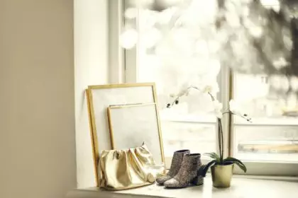 Home mockup with frames close up standing on windowsill with golden accessorie