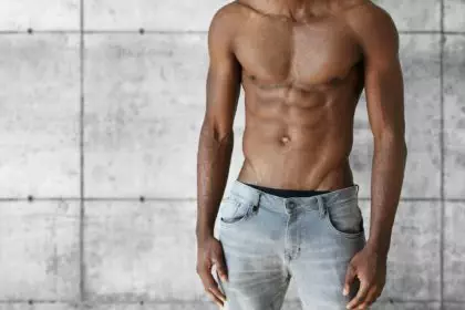 Young dark-skinned model with perfect toned muscular body. Handsome athletic African man in jeans de