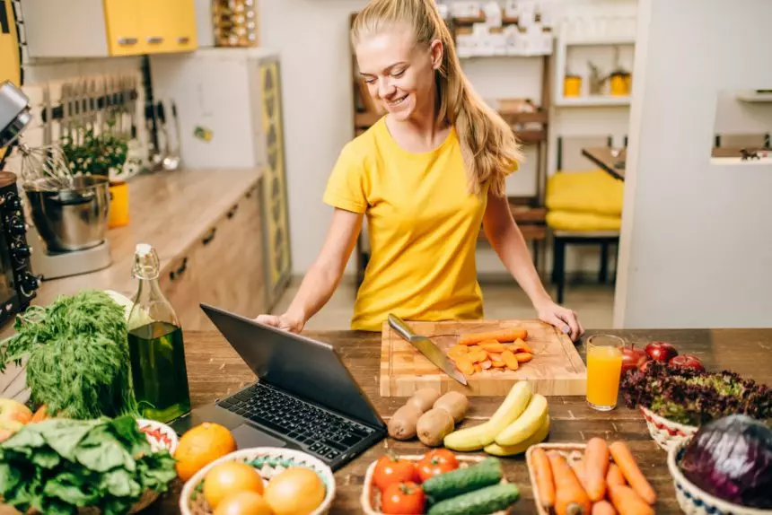 Young woman cooking on recipes, healthy food