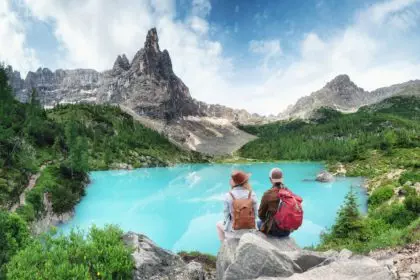 Tourist and Sorapis lake in the Italy. Travel and adventure with team