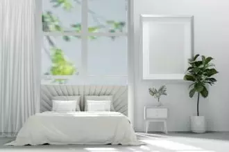 Bed in the bedroom in a Scandinavian minimalist style. Light pillows on the bed. 3D Render