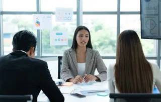 A group of young Asian entrepreneurs. Top Management is meeting to review stock investment data