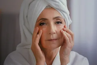 Close up portrait happy senior lady with anti wrinkle skin hydrogel collagen patches under eyes