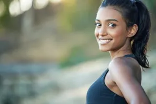 I run for fun and better health. Portrait of a sporty young woman exercising outdoors.